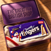 Cadbury Snowy Fingers carton nestled in cream wool inside plum pressed tin bearing The Great British Shop.